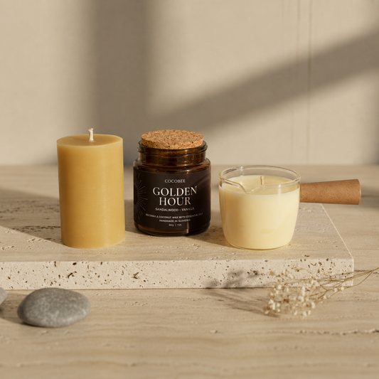Three candles on a wooden surface with a neutral background