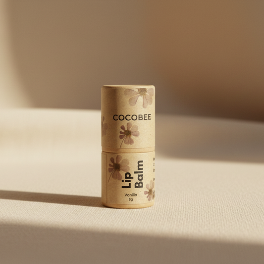 Cocobee lip balm on a beige surface with a soft background