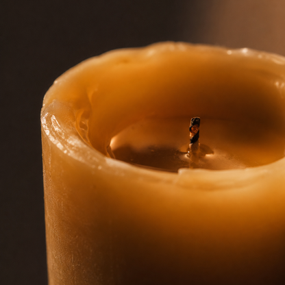 Close-up of a lit candle with a dark background