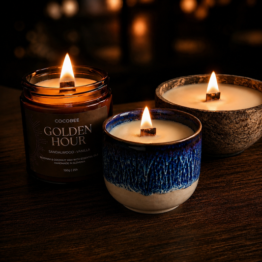 Three lit candles in different containers on a dark background